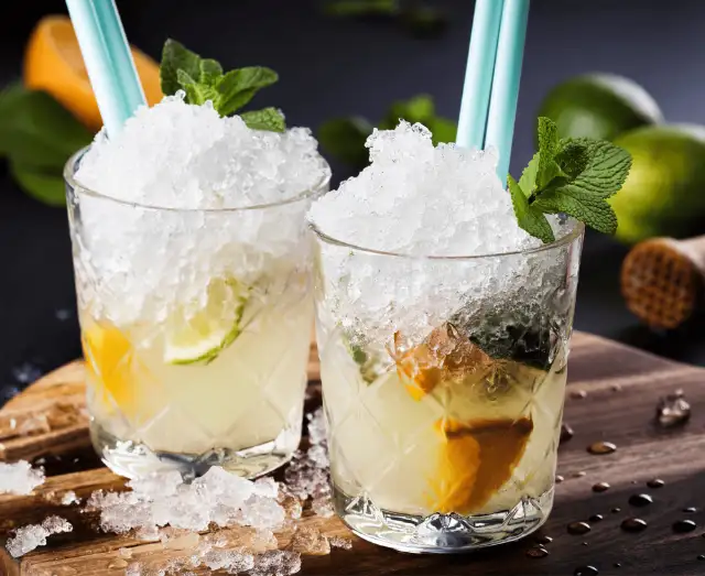 Two iced drinks topped with crushed ice